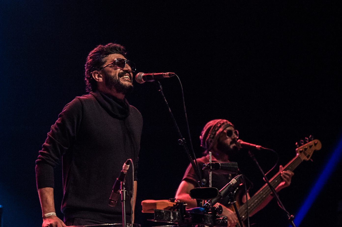 Yazan Al Rousan and Avo Demerjian of Jordanian indie band Autostrad performing on stage, singer at the microphone beside a guitarist under warm stage lighting
