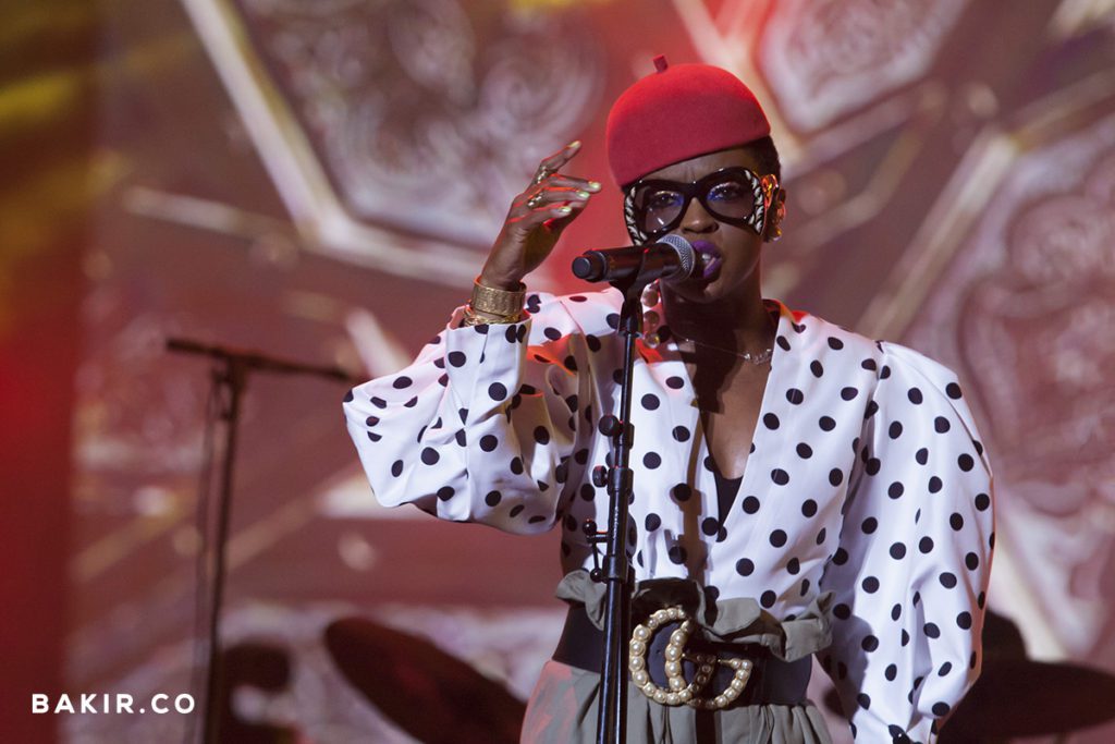 Singer in a red beret performing into a microphone on stage at the Mawazine music festival