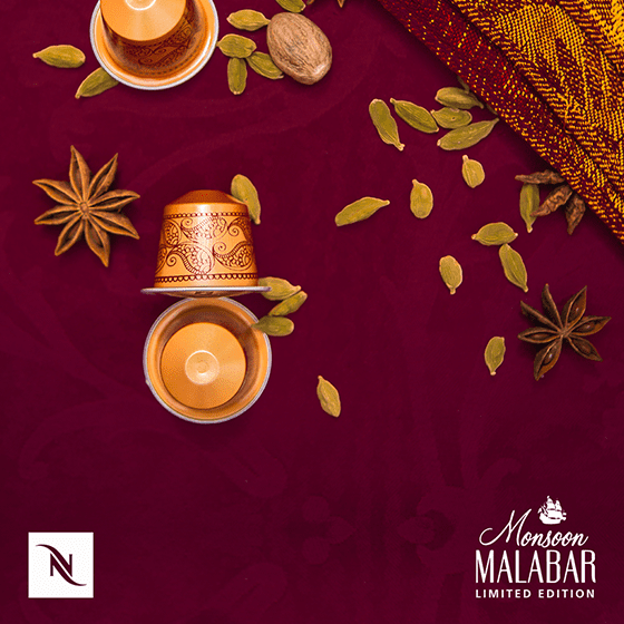Nespresso coffee capsules styled with cardamom and star anise spices on a deep red backdrop, Monsoon Malabar limited edition