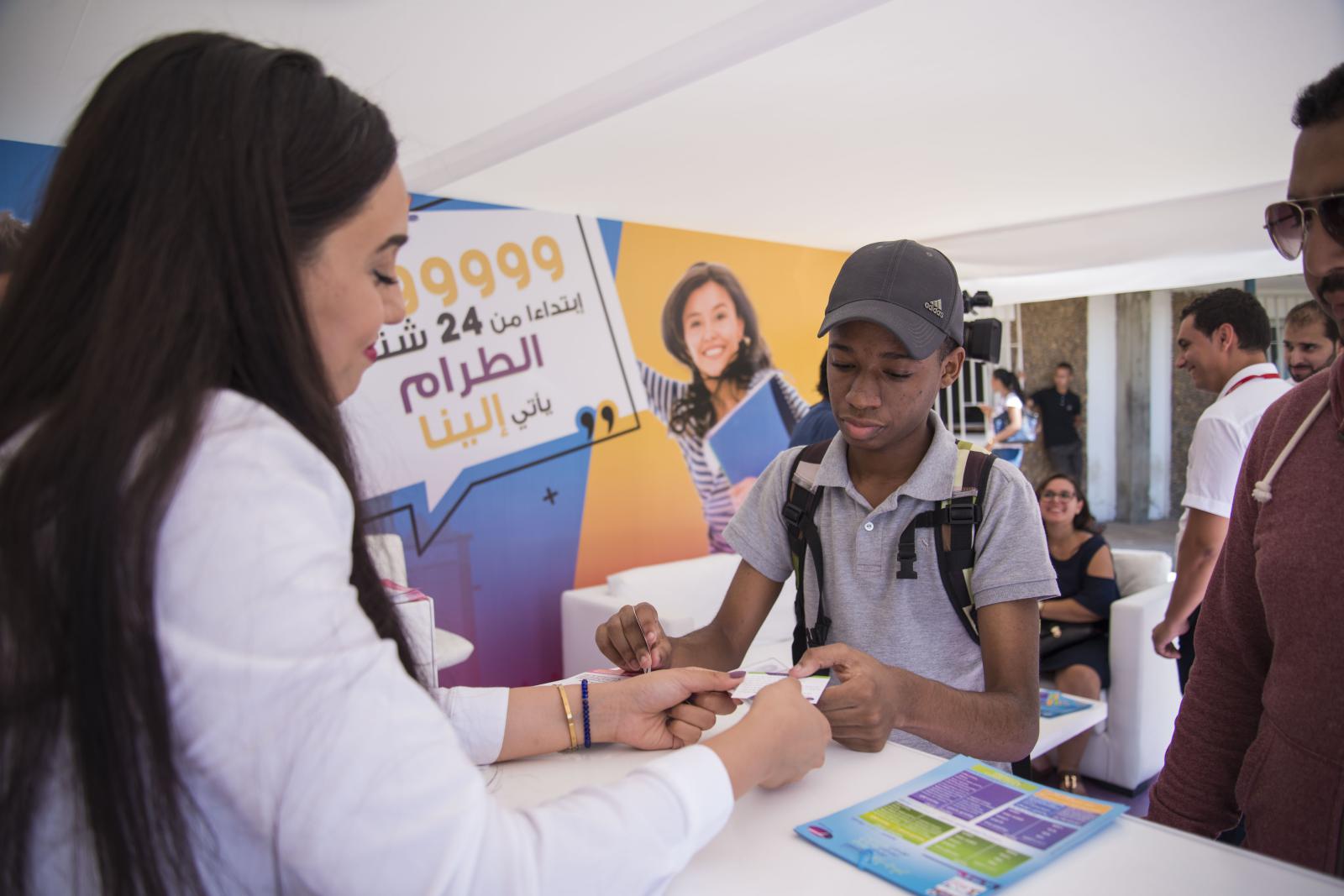 Woman engaging with students at an outdoor educational mobile stand event