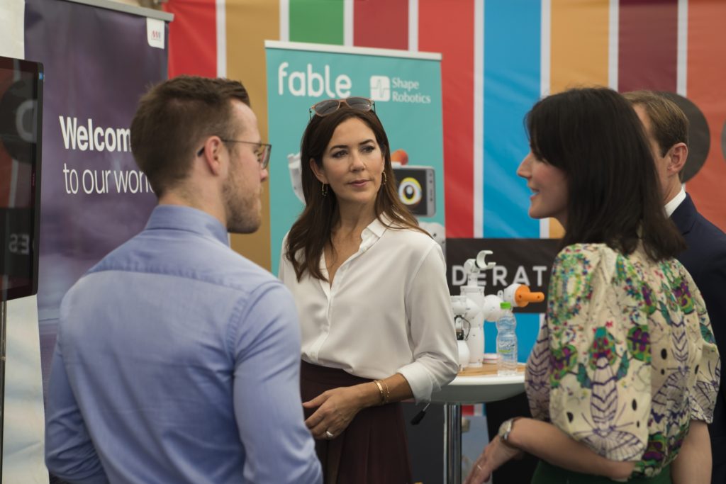 Young participants in conversation at an Innovation Lab booth during the Youth Innovation Summit