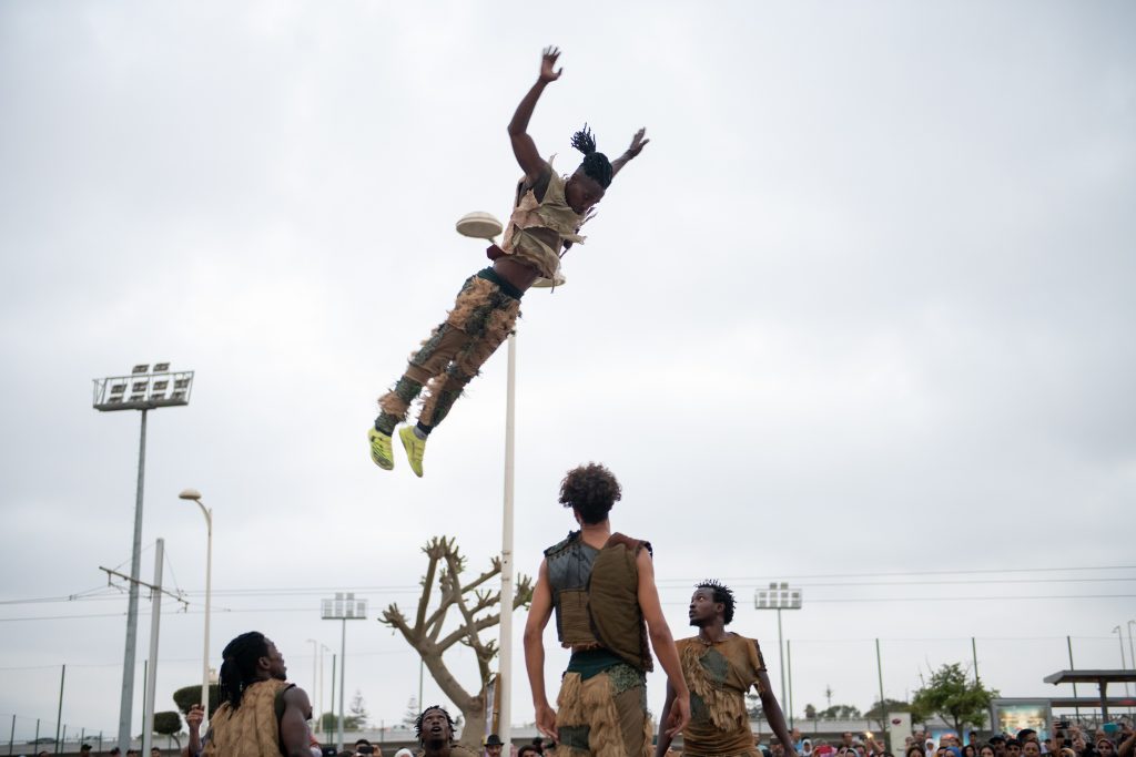 Dancer captured mid-jump in an outdoor plaza performance beside the Rabat-Sale tramway